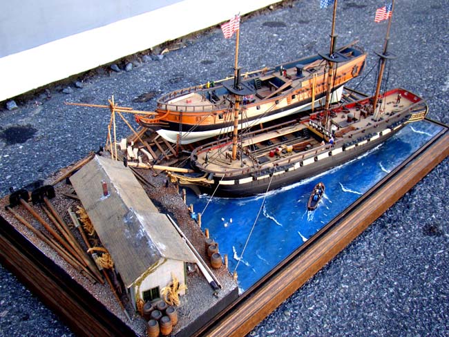 A fabulous and highly detailed scale model diorama circa 1920 of a New England Ship yard circa 1800-1812 making repairs on a 38 Gun American Frigate and a 10 Gun Privateer built circa 1785. — image 4